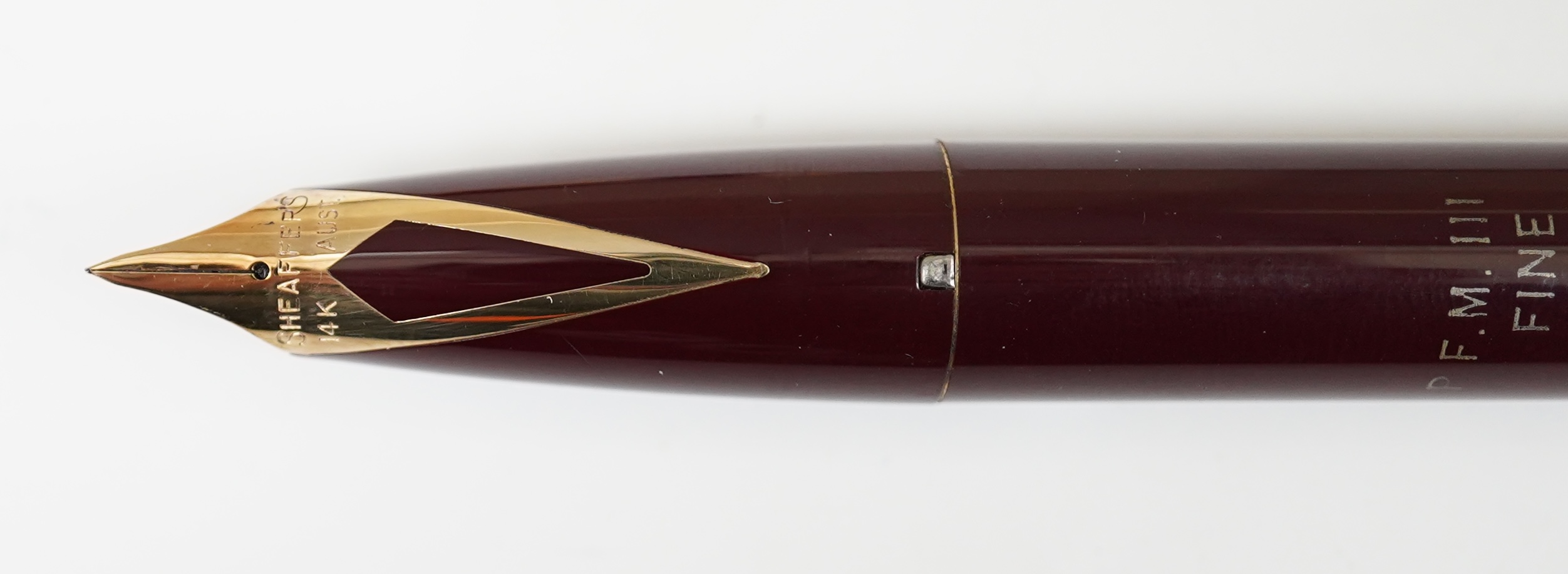 A Sheaffer PFM fountain pen in burgundy, with factory chalk marks to barrel